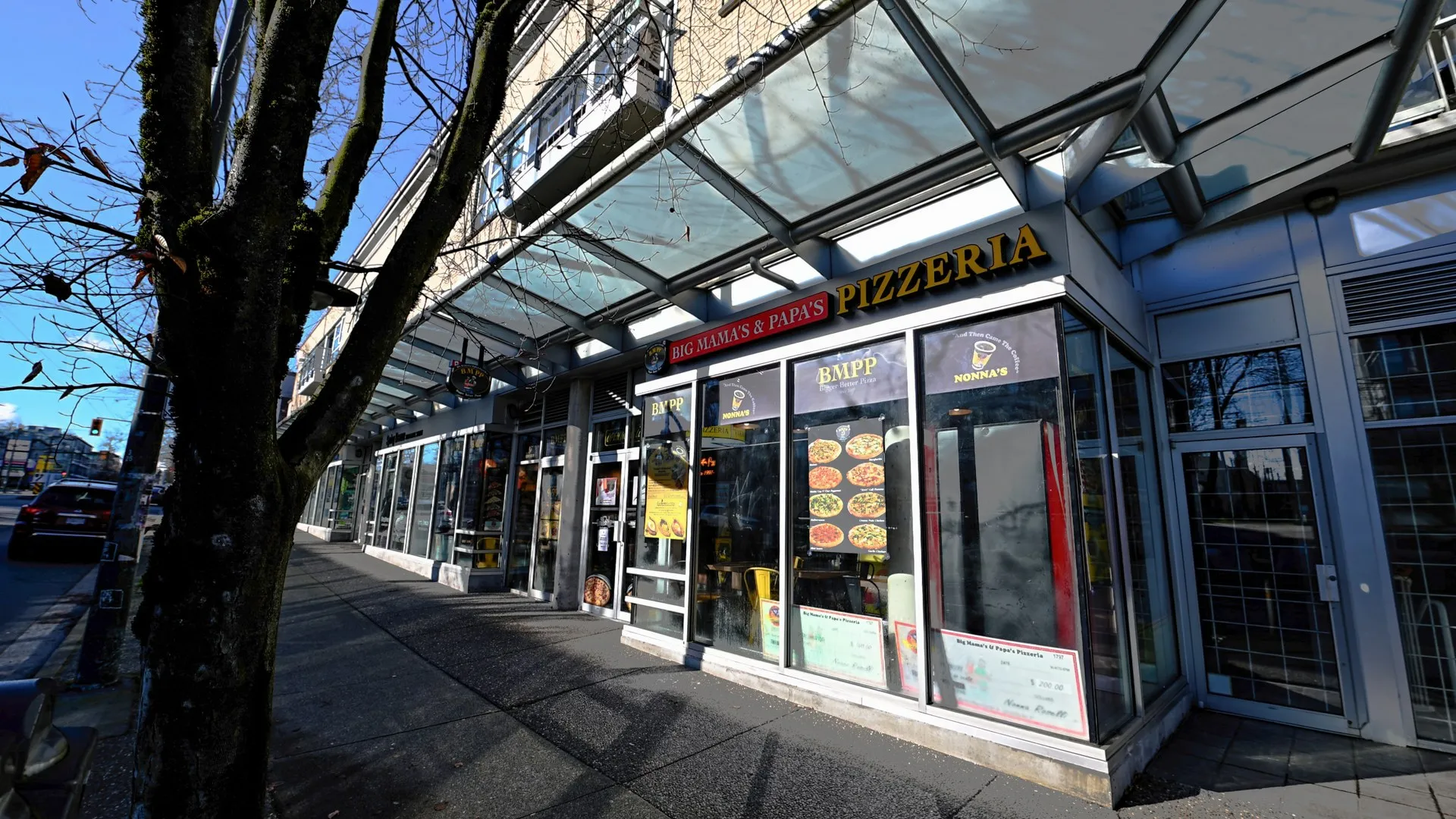 Modern corner glass storefront with Big Mama's & Papa's Pizzeria illuminated signage — BIG MAMA'S & PAPA'S PIZZERIA — SURREY, BC